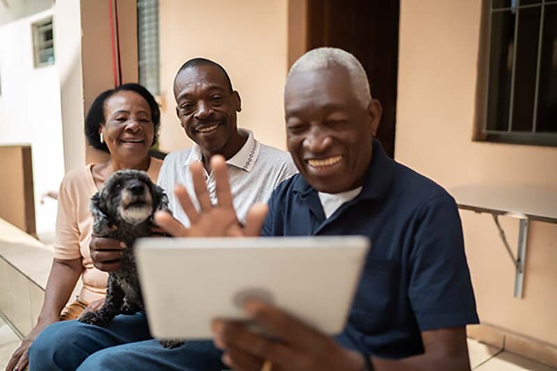 Family on a video calling using digital tablet at home